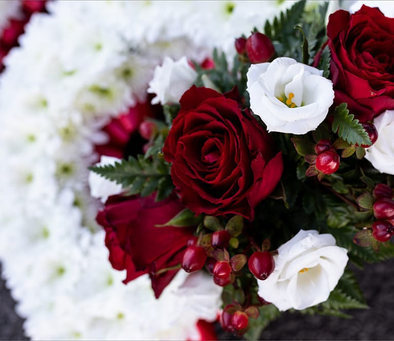 Red & White flowers on coffin